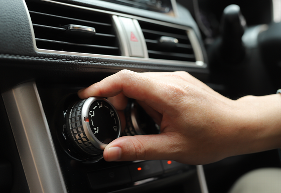 hand adjusting a car climate control knob in a vehicle interior featuring modern design and technology 4 settings for comfort