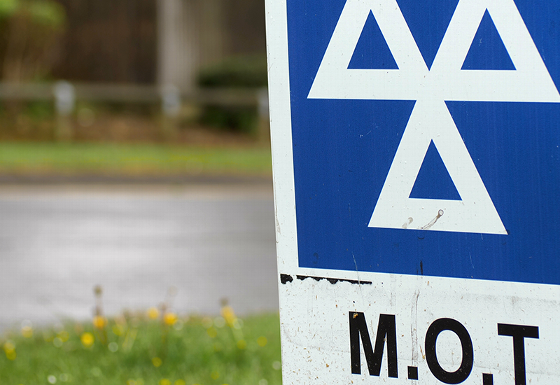 woman driving car smiling while adjusting controls in modern vehicle with focus on driving experience and advanced technology features including safety measures for road trips and travel plans at the age of 11